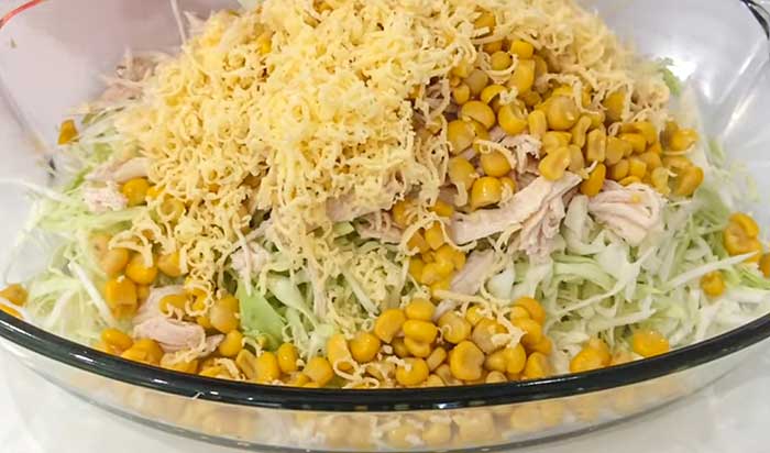 Соединиь капусту и курицу с кукурузой в салтнике с сыром